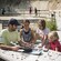 A man shows seashells to 4 girls